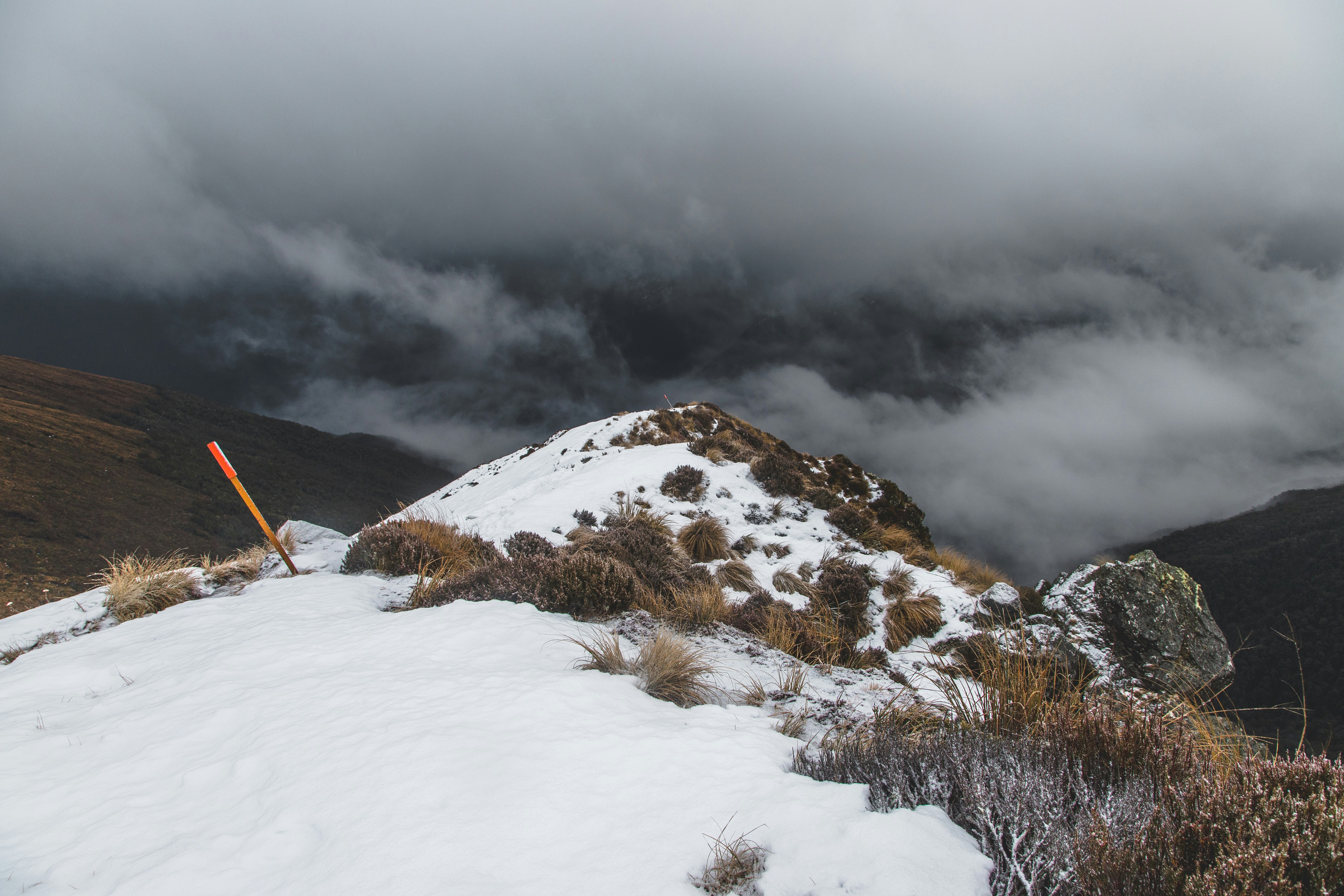 snow covered mountain under gray clouds